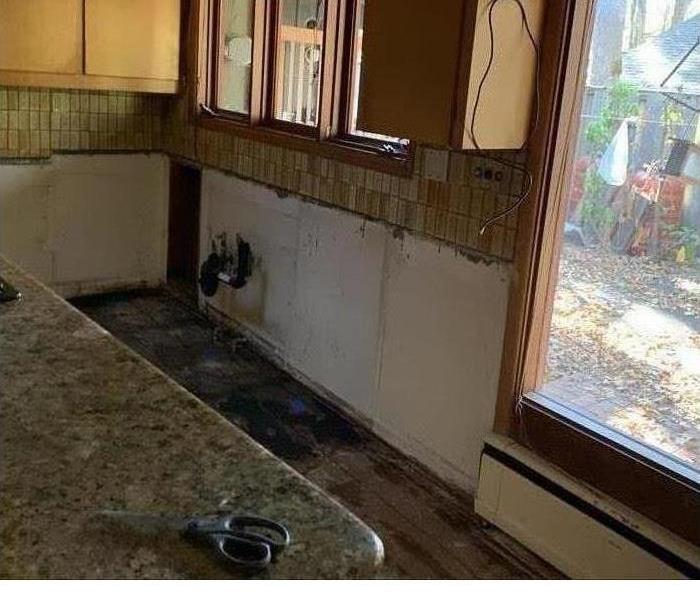 Water damaged kitchen with cabinets and counters removed
