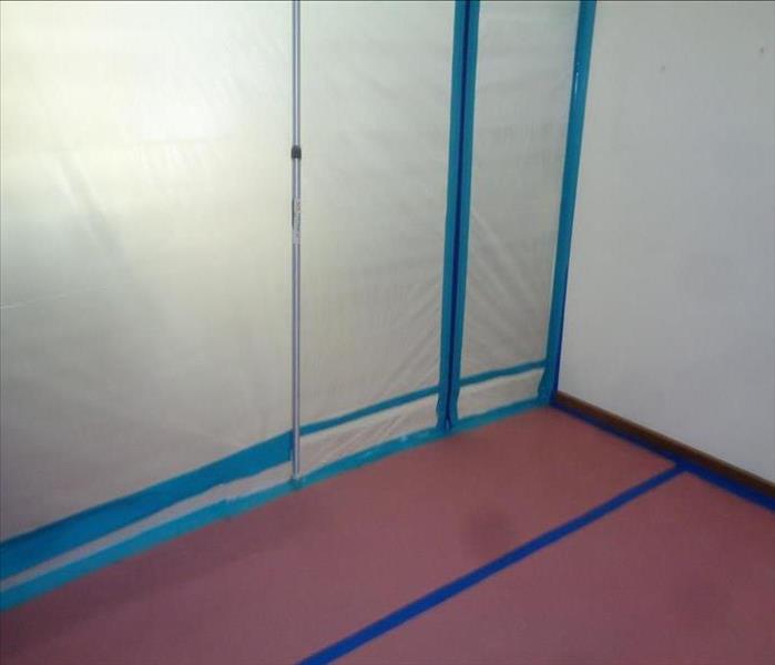 containment of open walls with plastic and blue tape