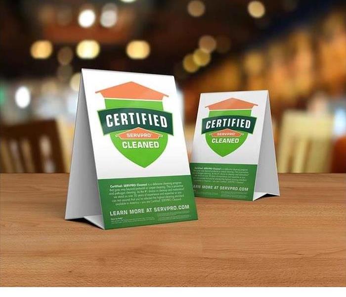 Table signs with SERVPRO certified clean on them