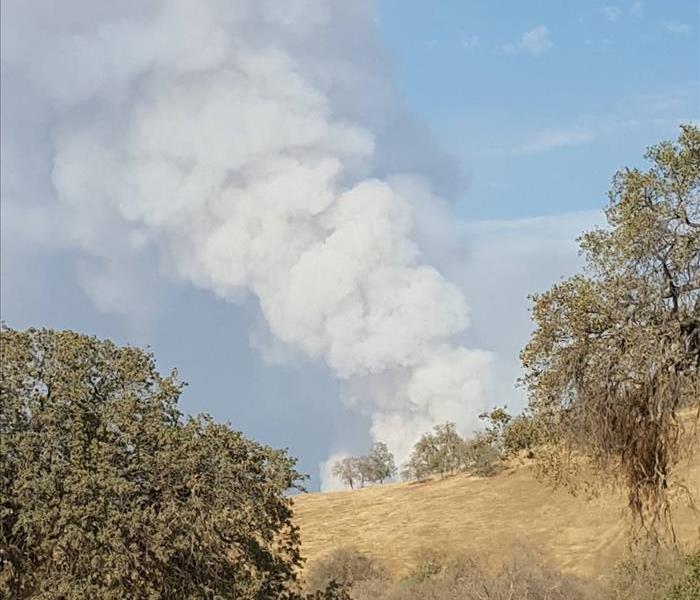 plume of smoke in a residential area